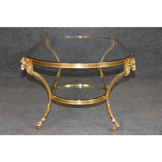 An exceptionally elegant brass and glass coffee table in the style of Maison Jansen, combining French neoclassical...