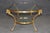 An exceptionally elegant brass and glass coffee table in the style of Maison Jansen, combining French neoclassical...