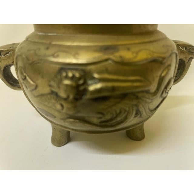 This 19th-century Chinese tripod censer is a beautiful example of late Qing Dynasty metalwork. Cast in solid bronze, the...