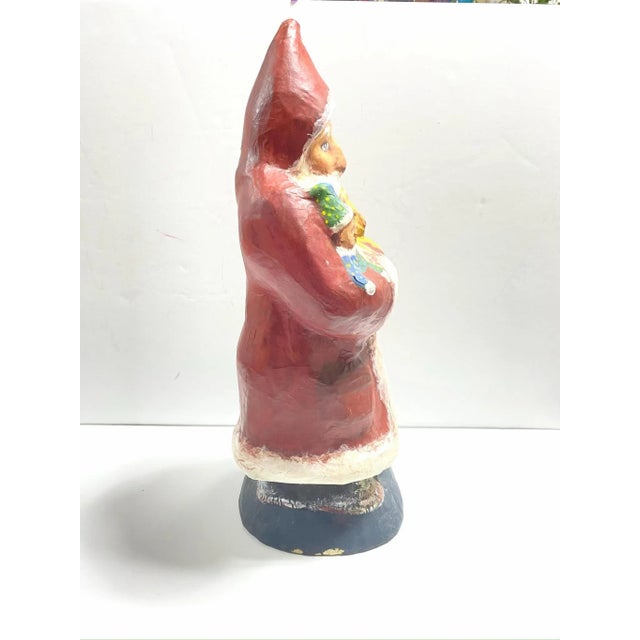 A wonderful vintage folk art Santa crafted from paper mache and beautifully hand painted with a warm, expressive face. He...