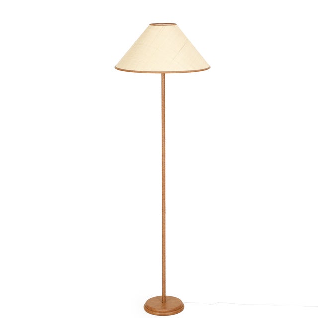 The Keria Floor Lamp brings warmth and texture to any corner. Its vegan leather-wrapped base and pillar feel grounded and...