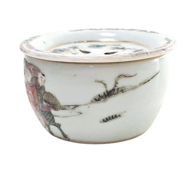 An exquisite remnant of Qing artistry, this Famille rose porcelain cricket pot portrays a narrative scene of scholars and...