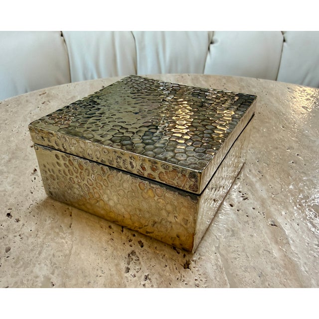 Elegant vintage Italian rectangular box crafted in richly textured hammered brass. Its warm golden finish and organic...