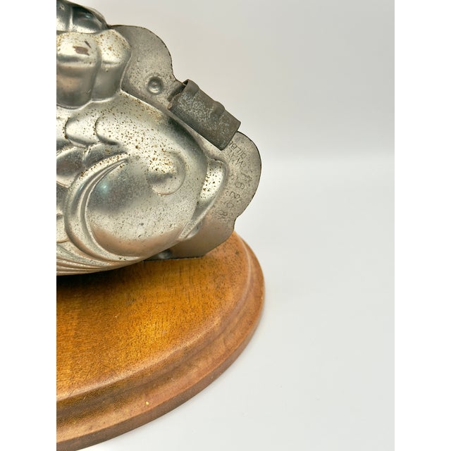 This vintage Belgian chocolate mold stamped “Waldek Dilbeek” is a striking piece of culinary history turned decorative...