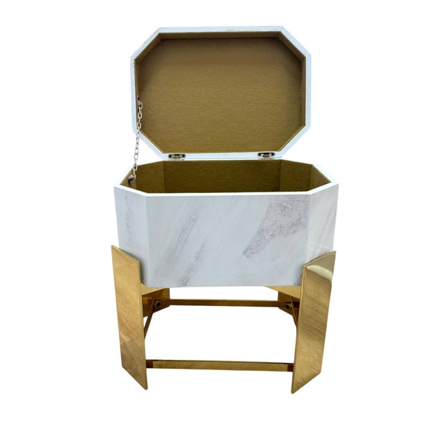 Sculptural octagonal storage table attributed to Karl Springer, featuring a high-gloss faux stone laminate exterior set on...