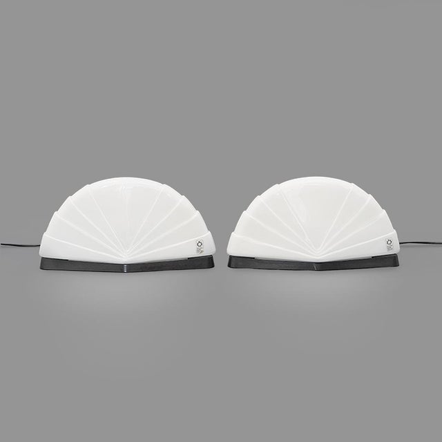 Pair of Italian-made “Flores” table lamps, produced by Leucos in the 1980s and designed by Paolo Nava. Each lamp features...