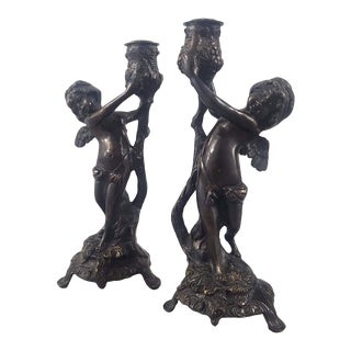 Pair of Vintage Bronze Metal Cherubs Holding Urns Wings Candle Holders For Sale