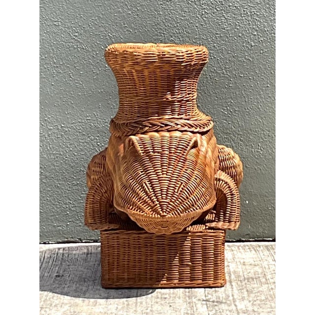 This delightful vintage woven rattan frog table captures mid-20th-century whimsy and functional design, expertly...