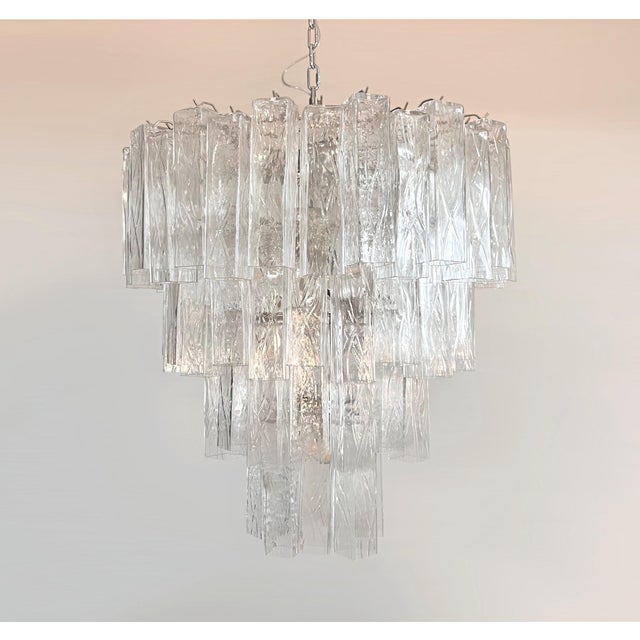 An impressive Italian Murano glass chandelier featuring a dramatic four-tier design with 80 large clear square prism tubes...