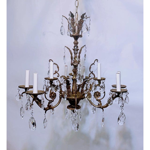 Decorative vintage Spanish style brass chandelier with hand cut faceted glass spears and Swedish cut crystal prisms. The...