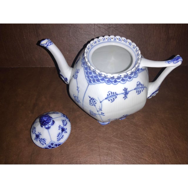 Full lace identified by open work pierced lace framing top rim. The basis of the spout and geometric handle are molded...