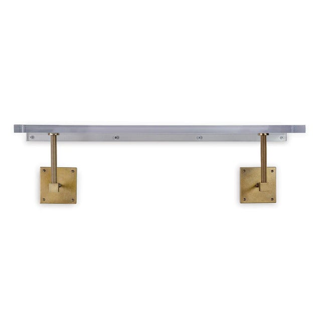 Billy is the 36" wide lucite single wall shelf which features aged brass finished metal and knurled support pole hardware....