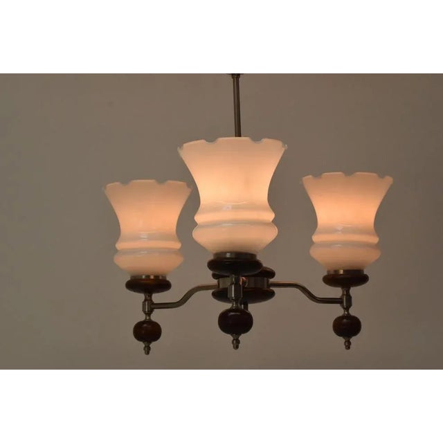 Made in czechoslovakia. Made of wood, chrome and glass. 3 x e27 or e26 bulb. Us wiring compatible. With aged patina. Wear...