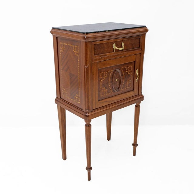 An elegant pair of Italian Louis XVI-style bedside tables, crafted from solid walnut and embellished with refined...