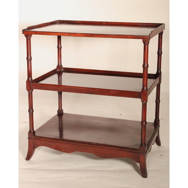 Pair of English Regency style mahogany 3 tier end tables, circa 1920. The top with a raised side and back gallery, 3...