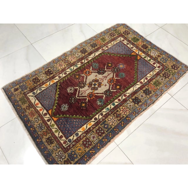 This is a vintage Turkish Oushak rug from the 1960s. The piece was hand-knotted.