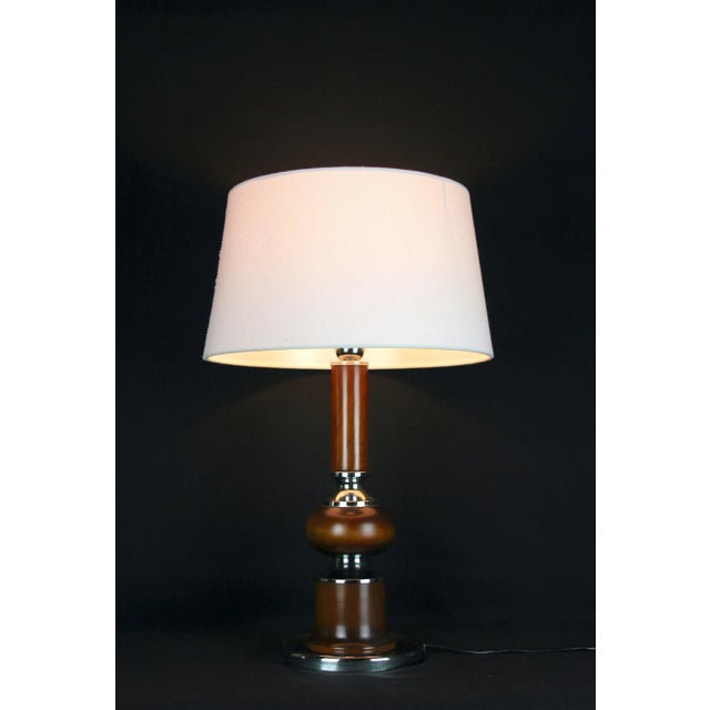 Very classic table lamp, The foot is a mix of chrome and wood, the base, heavier, is in chrome, inspired by Barbier. This...