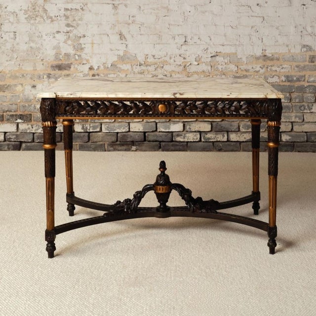 Add rich French elegance to your space with this 19th century French dark wood base and marble top table, a beautifully...