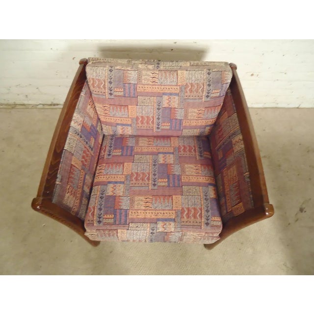 Wonderful pair of unique vintage mid-century modern arm chairs! A sculpted rosewood frame holds a plush upholstered seat...