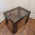 Vintage smoked Lucite (acrylic) end table with a thick beveled top and four broad slab-style legs. The translucent smoked...