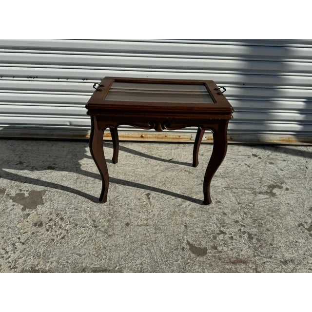 With a removable serving tray, this side table is unique. Dating from the 1940's, its made of walnut. It has cabriole legs...