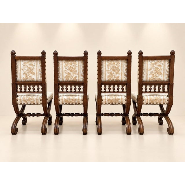 Four superb Neo-Renaissance style chairs in solid carved walnut, testaments to the high-quality joinery of the last third...