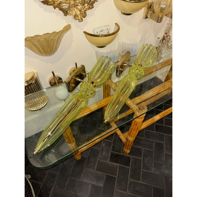 The product is a pair of Murano green torch form sconces. These sconces are likely to be handcrafted, unique pieces that...