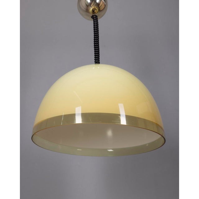 Pendant lamp with large yellow plastic lampshade, Baobab model, designed by Guzzini This piece has an attribution mark, I...