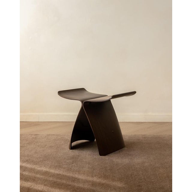 A vintage japanese mid-century modern butterfly stool in rosewood-veneered moulded plywood, designed by sori yanagi and...