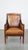 This slender sheep leather and wooden vintage Art Deco design armchair in a beautiful warm cognac color. This great...