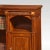 Mahogany inlaid corner bookcase. The well-figured large rectangular lipped top above carved freeze, to the adjustable...