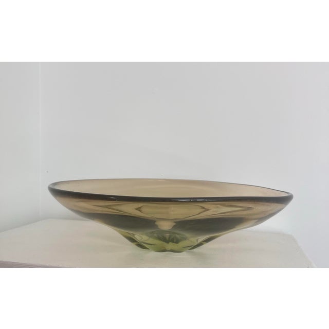 A stunning, heavy glass, centerpiece bowl with an organic undulating design meant to replicaate a flower petal motif....