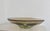 A stunning, heavy glass, centerpiece bowl with an organic undulating design meant to replicaate a flower petal motif....