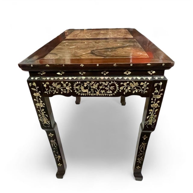Chinese table with marble insets in the top and mother of pearl decoration on the apron and legs. The right hand marble...