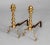 Pair of American brass and iron andirons with matched tools, turned and faceted finials, spurred legs on ball feet. The...
