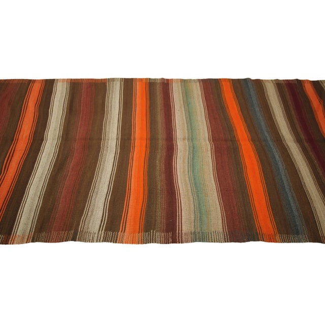 Handwoven vintage striped kilim rug from Kars region of Turkey. Approximately 50-60 years old. In very good condition