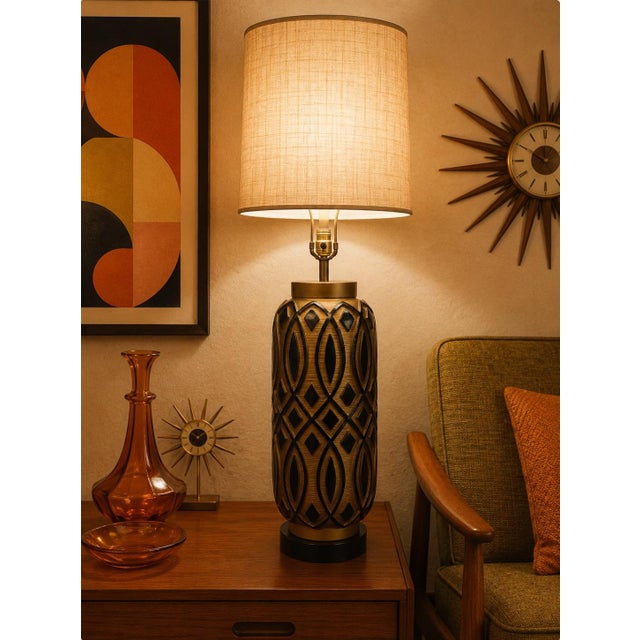 This is a large oversized vintage sculptural table lamp featuring a cylindrical body adorned with raised geometric...