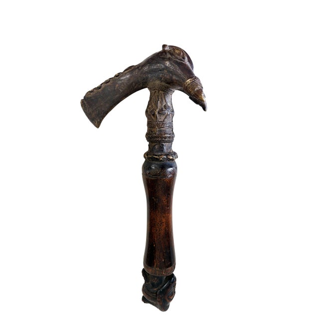 A rare Senufo cast bronze figural axe (kpa'ana) from Côte d'Ivoire, this highly revered ceremonial piece features a bird...