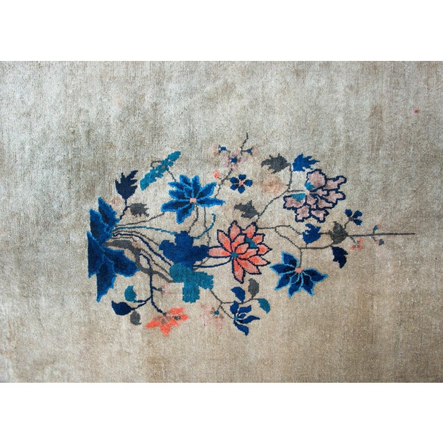 A beautiful early 20th century Chinese Feti rug with a gray field surrounded by a thin orange stripe a wide indigo stripe,...
