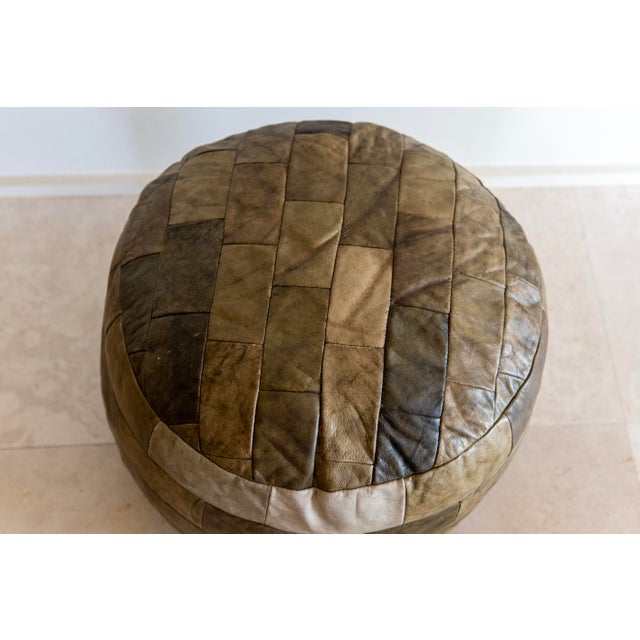 A beautifully worn vintage leather pouf by De Sede, crafted in Switzerland and upholstered in the company's signature...