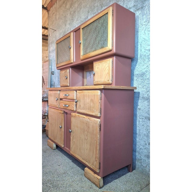 A two-piece, refurbished mado kitchen buffet from the 1950s, crafted from solid wood (pine or ash), with lines typical of...