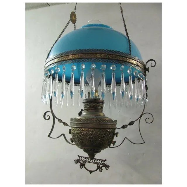 BEautiful victorian blue shaded lamp with hanging crystals and brass bottom with the decoration of grapes. 39" H x 16" W