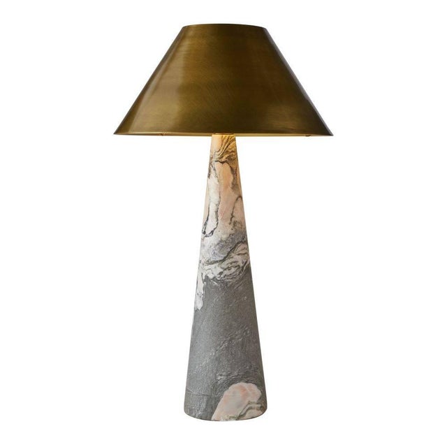 A slender cone of calacatta viola marble meets a tapered antique brass shade to create an unexpected balancing act of...