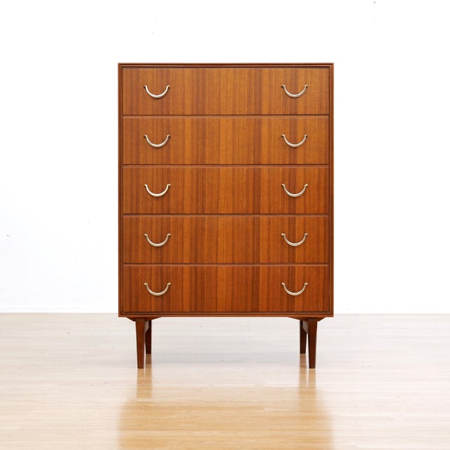 This vintage six drawer tallboy dresser was designed and manufactured by Meredew of Letchworth, Hertfordshire UK during...