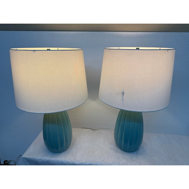 Design Plus Gallery presents a Pair of Glazed Ceramic Table Lamps in a Turquoise Tone. Their fluted bodies bring dimension...
