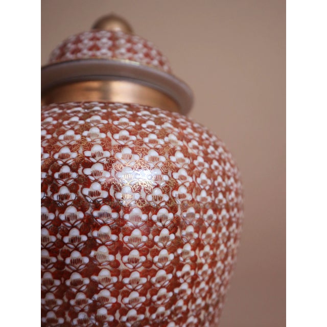 Large Kutani ginger jar with classic hourglass silhouette. Hand-painted in vibrant hues of tangerine, gold, and white. Lid...
