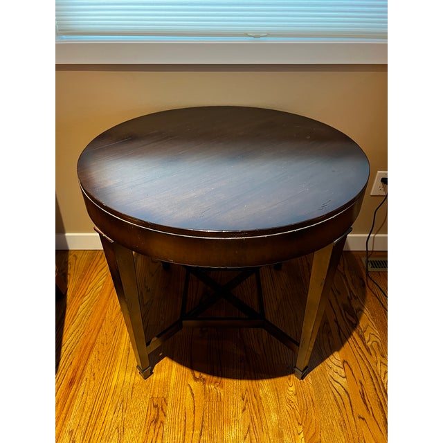 I put this versatile round table between a pair of chairs and ottomans. Perfect height and size. Clean and smooth curves.
