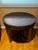 I put this versatile round table between a pair of chairs and ottomans. Perfect height and size. Clean and smooth curves.