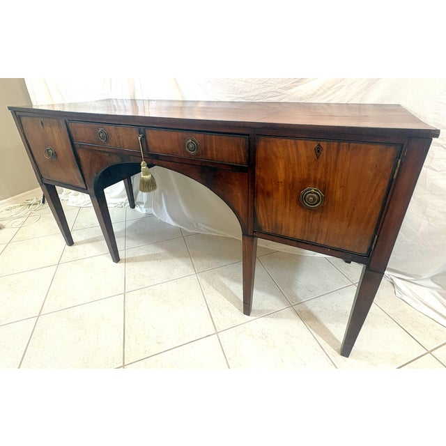 Wonderful antique Georgian style sideboard from the early 1900's. The handmade piece is made of mahogany and inlaid...