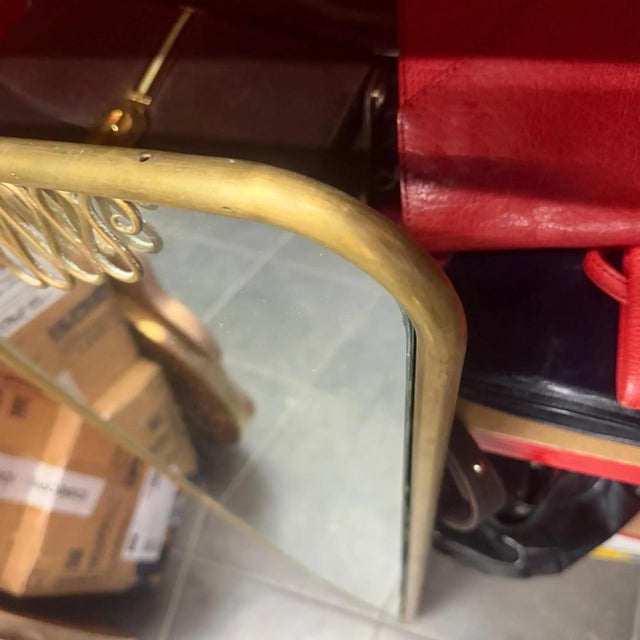 This stunning vintage 1960s Gio Ponti style mid-century modern brass and glass wall mirror featuring an eye-catching...